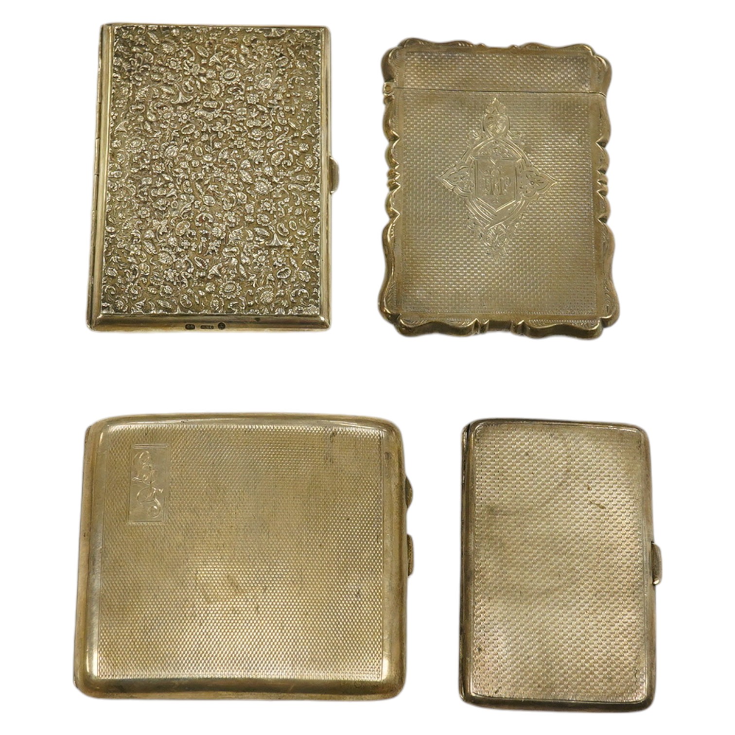 A Victorian engine turned silver card case, maker George Unite, Birmingham 1878, two later engine turned cigarette case, 7 oz, and a Victorian floral embossed silver notecase, gross 4 oz. Condition - fair to good.